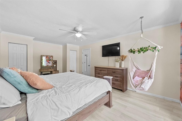 bedroom featuring crown molding, light wood finished floors, a ceiling fan, and baseboards