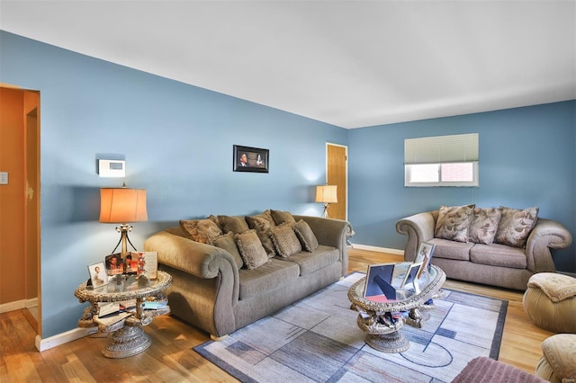 living room with wood finished floors and baseboards