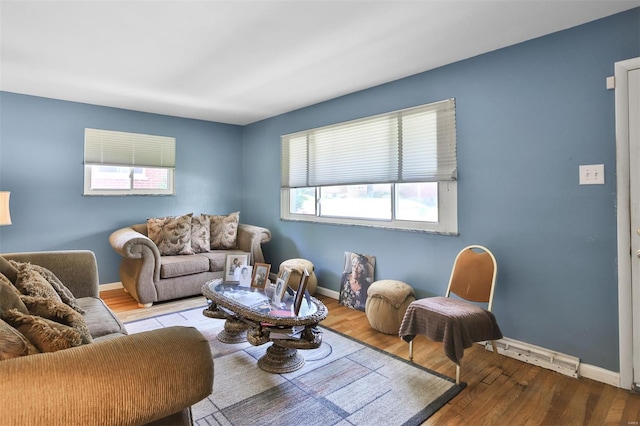 living area with wood finished floors and baseboards