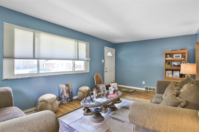 living area with wood finished floors and baseboards