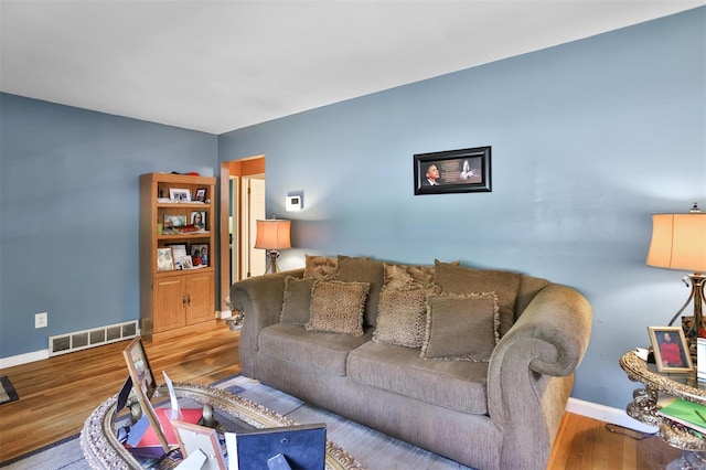 living room with baseboards and wood finished floors