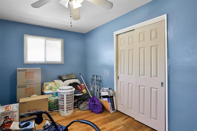 bedroom featuring wood finished floors, a closet, and ceiling fan
