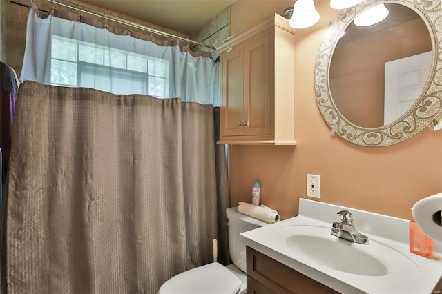 bathroom with toilet, vanity, and a shower with curtain