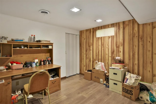 office area featuring wooden walls and light wood finished floors