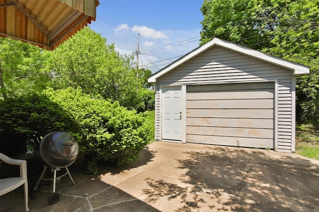 detached garage featuring concrete driveway