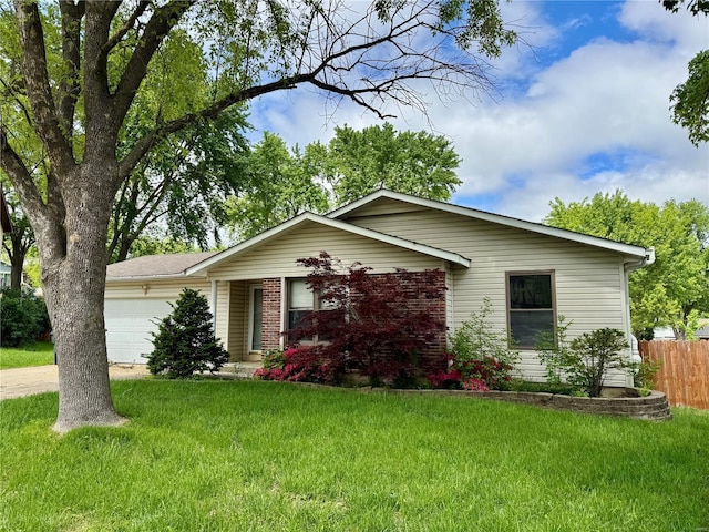 view of front of home featuring a front yard, a garage, and fence