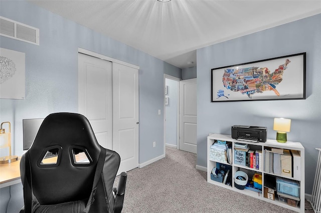 sitting room with carpet floors, baseboards, and visible vents