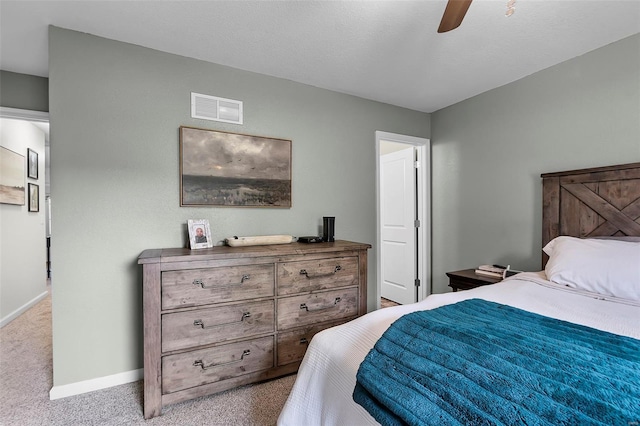 bedroom with baseboards, ceiling fan, visible vents, and carpet