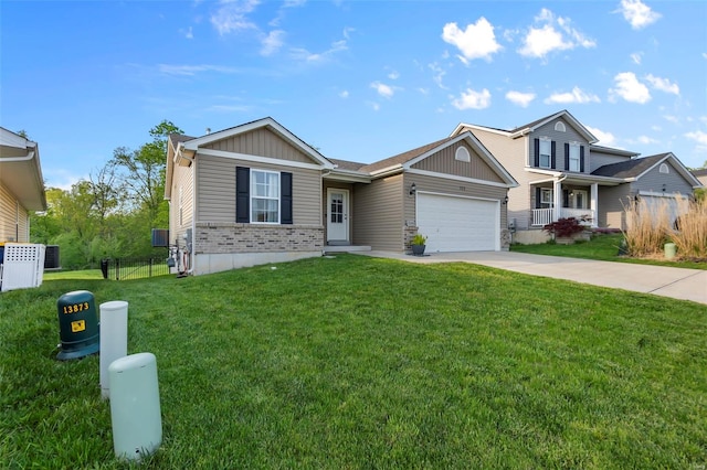 view of front of property with driveway, board and batten siding, fence, a garage, and a front yard
