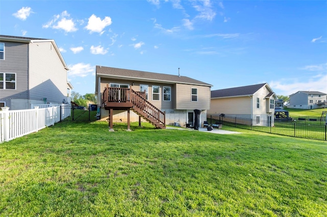 rear view of property with a yard, a patio, stairs, a wooden deck, and a fenced backyard