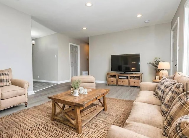 living area featuring wood finished floors, baseboards, and recessed lighting