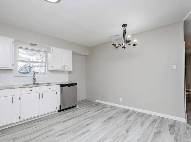 kitchen with a sink, dishwasher, an inviting chandelier, light wood-style flooring, and white cabinetry