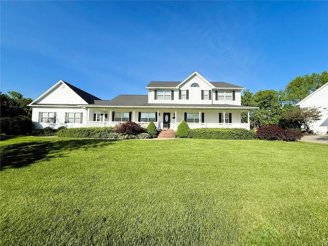 traditional-style home featuring a front yard and a porch