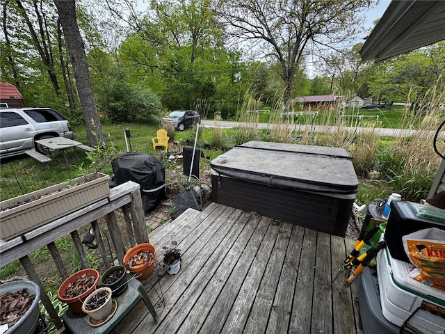 wooden deck featuring a hot tub