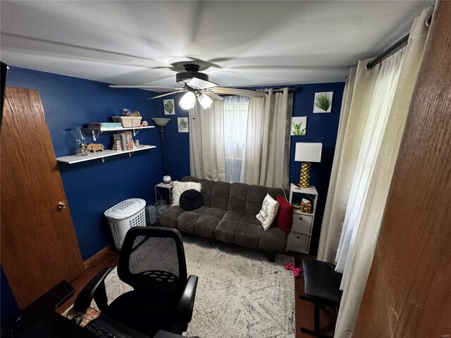living area featuring ceiling fan and wood finished floors