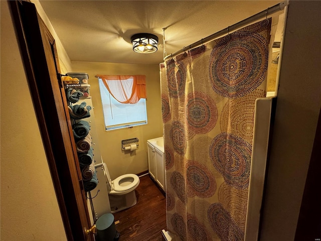 full bathroom featuring toilet, a shower with curtain, and wood finished floors