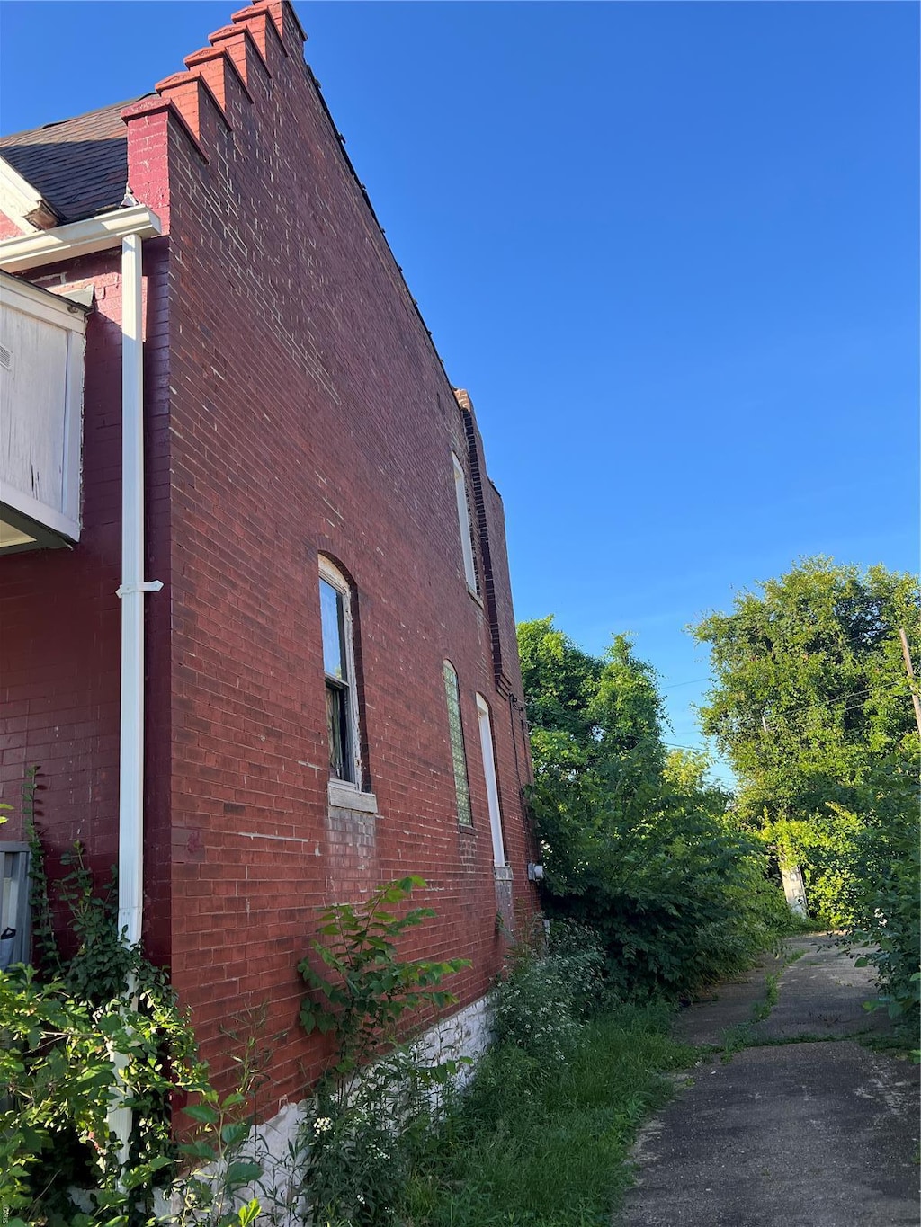 view of side of property featuring brick siding