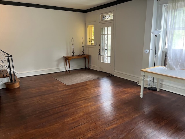 entrance foyer with hardwood / wood-style floors, crown molding, and baseboards