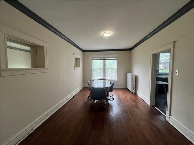 dining area featuring radiator heating unit, crown molding, dark wood-style floors, and baseboards