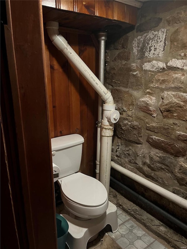 bathroom with toilet and tile patterned floors