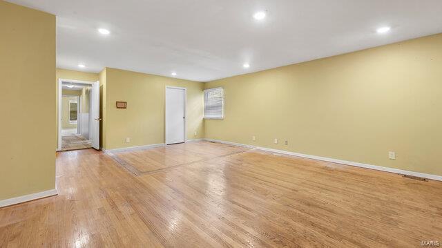 unfurnished room featuring baseboards, recessed lighting, and light wood-type flooring