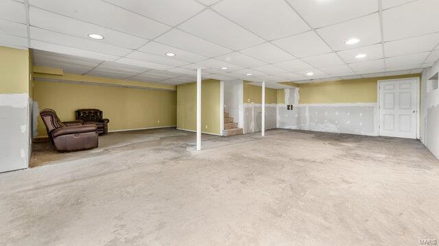 finished basement featuring stairs and recessed lighting