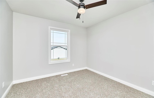 empty room with ceiling fan, carpet flooring, baseboards, and visible vents