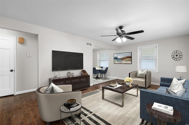 living room with visible vents, wood finished floors, baseboards, and ceiling fan
