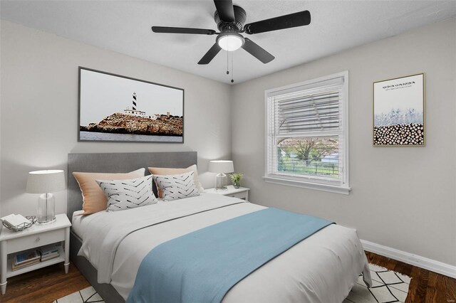 bedroom with baseboards, a ceiling fan, and wood finished floors