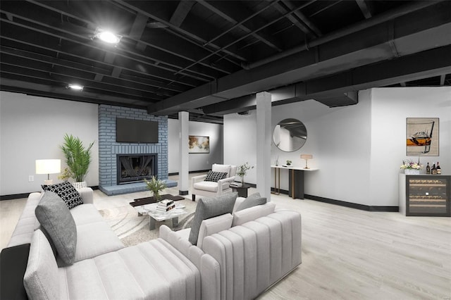living area with light wood-type flooring, baseboards, and a fireplace