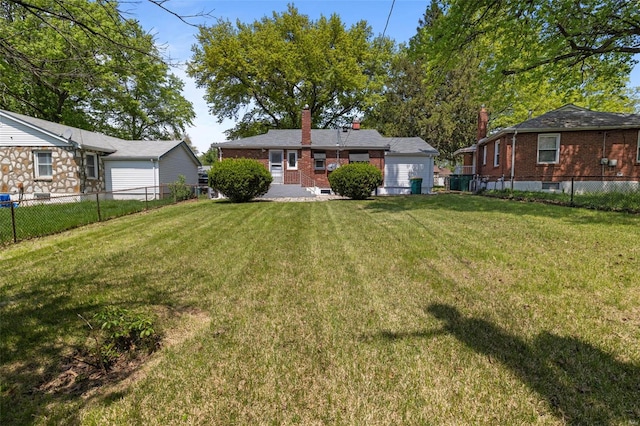 view of yard with a fenced backyard and a garage