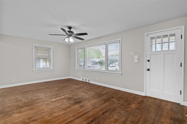 foyer with visible vents, baseboards, a ceiling fan, and dark wood-type flooring