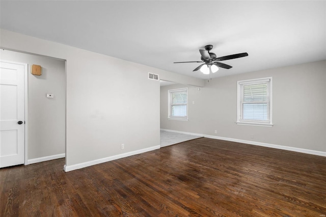 unfurnished room with baseboards, a ceiling fan, visible vents, and wood finished floors