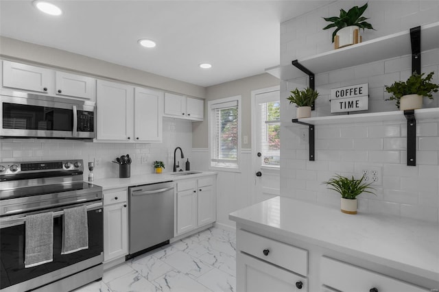 kitchen featuring open shelves, white cabinets, marble finish floor, and appliances with stainless steel finishes