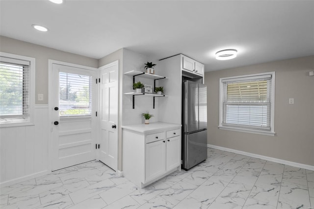 kitchen with marble finish floor, freestanding refrigerator, open shelves, recessed lighting, and light countertops