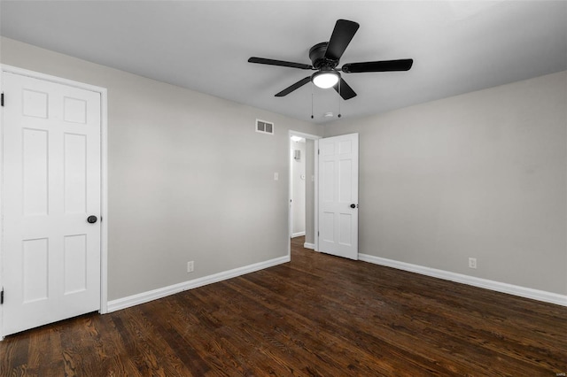 unfurnished bedroom featuring baseboards, ceiling fan, visible vents, and wood finished floors