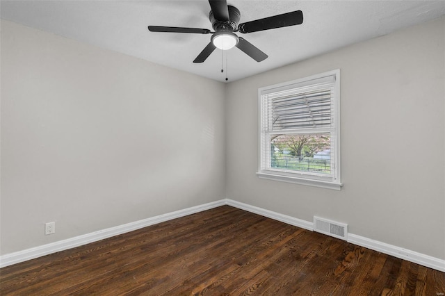 unfurnished room featuring dark wood-style flooring, visible vents, baseboards, and ceiling fan