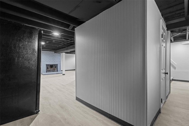 hallway featuring baseboards and light wood-type flooring