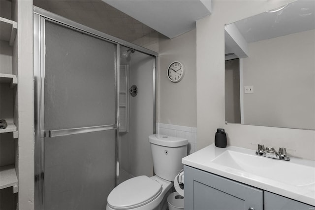 full bath with vanity, toilet, and a shower stall