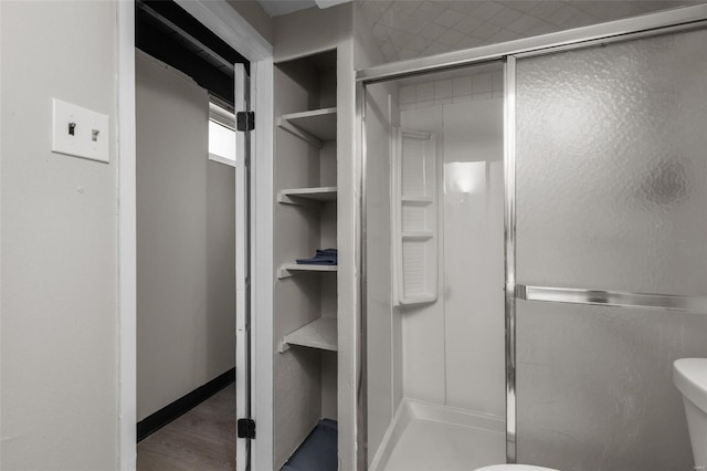 full bath featuring toilet and a shower stall