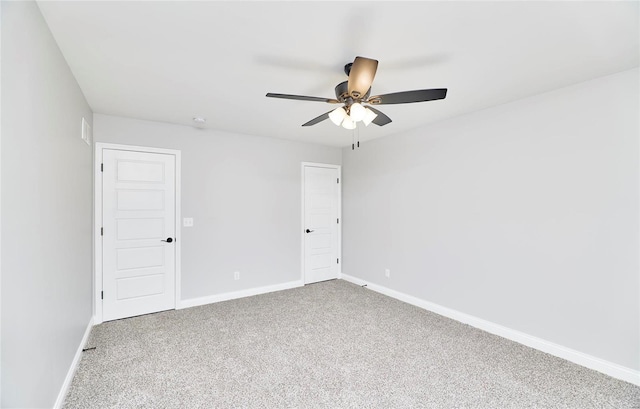 spare room featuring a ceiling fan, baseboards, and carpet floors