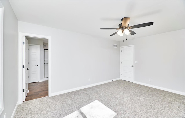 unfurnished bedroom featuring baseboards, carpet flooring, visible vents, and a ceiling fan