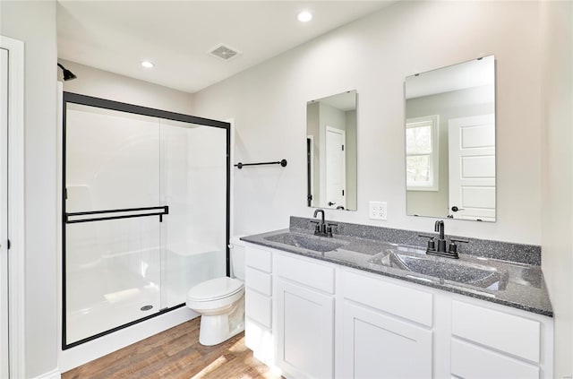 bathroom with a sink, a stall shower, and visible vents
