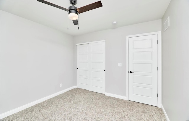 unfurnished bedroom with light colored carpet, a closet, visible vents, and baseboards