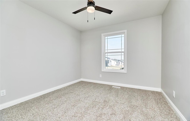 unfurnished room featuring ceiling fan, carpet floors, baseboards, and visible vents