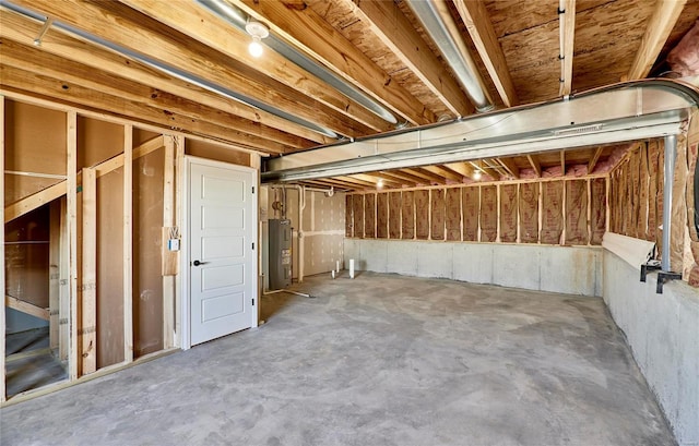 unfinished below grade area featuring water heater