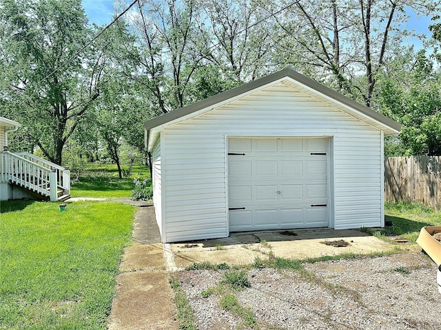 detached garage featuring fence