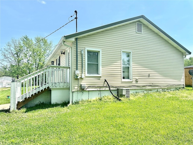 view of property exterior with a lawn