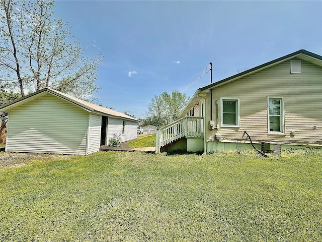 view of side of home with a lawn