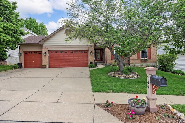 view of front of home featuring driveway, a garage, brick siding, and a front yard